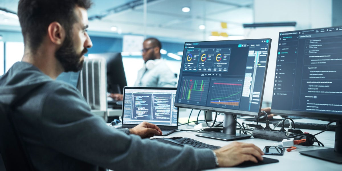 man in front of computer software